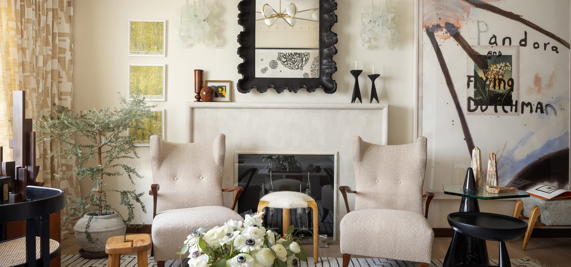 Pirela Atelier. High-end interior detail showing modern art and a pair of textured cream-colored armchairs.